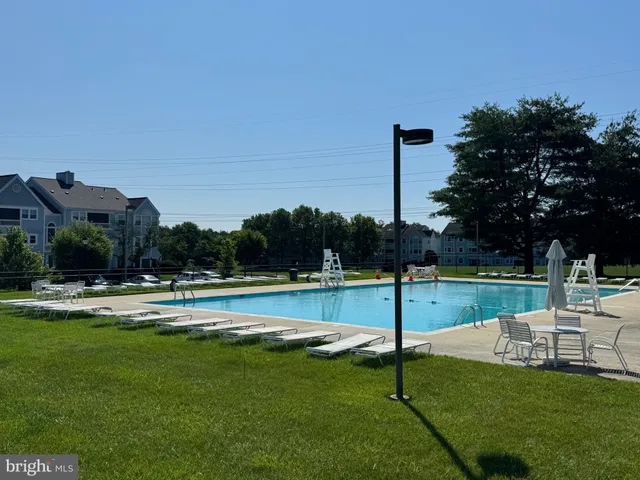 a view of a swimming pool with a yard