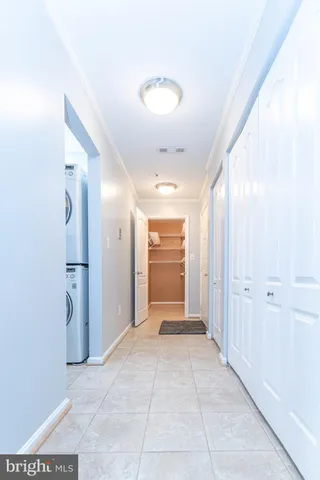 a view of a hallway with wooden shelves