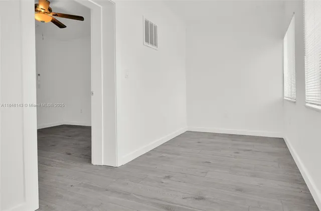 a view of a room with wooden floor