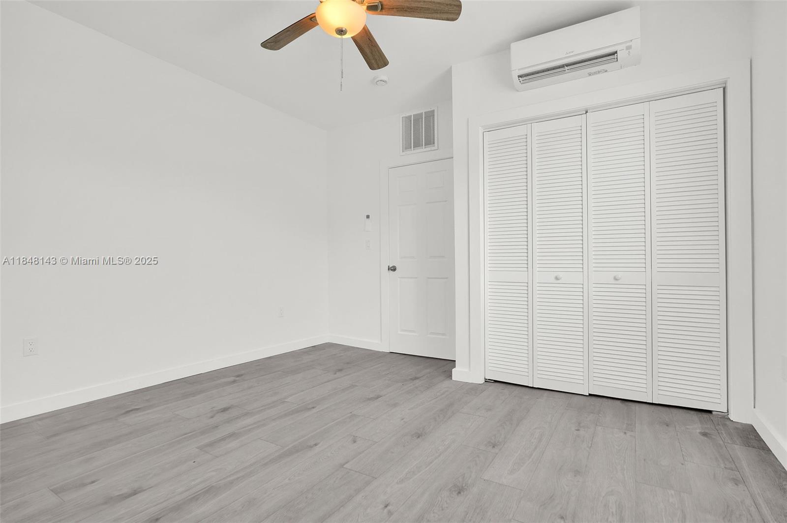 600 Northwest 25th Court Miami, FL 33125 - Photo 13 of 16 a view of an empty room with wooden floor