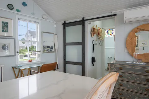 a roof deck with couch and wooden floor