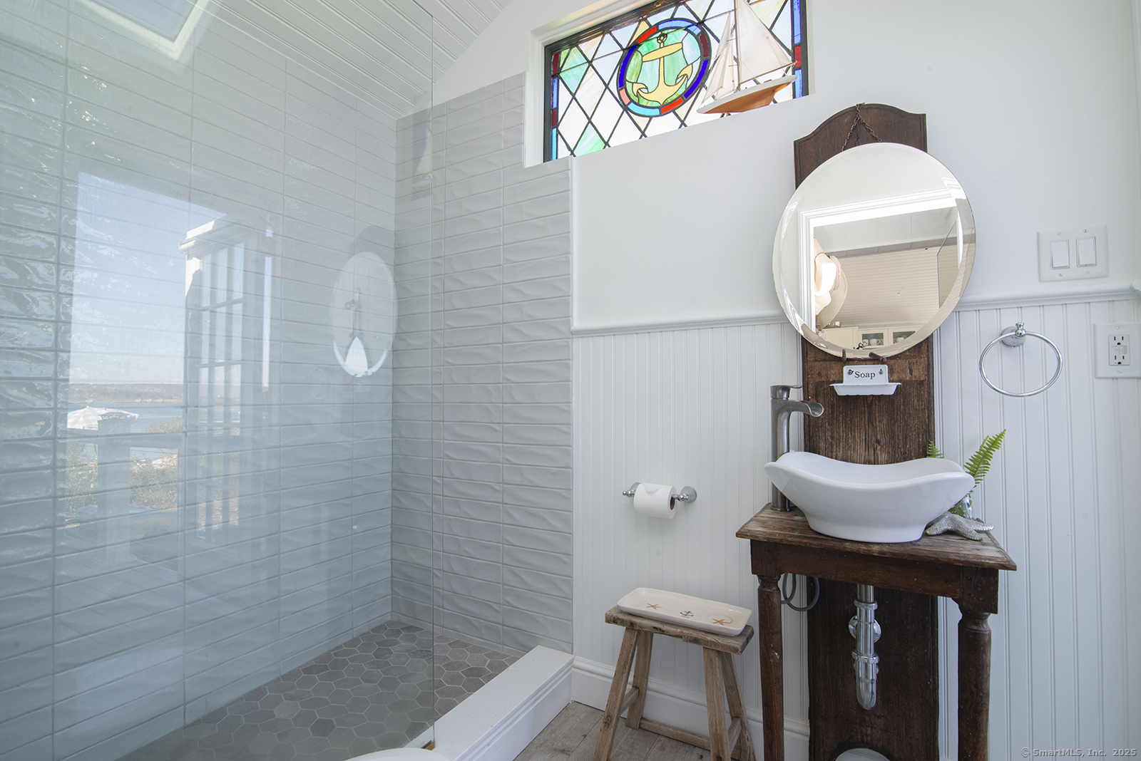 114 Jupiter Point Road Groton, CT 06340 - Photo 17 of 34 a bathroom with a sink a mirror and a shower