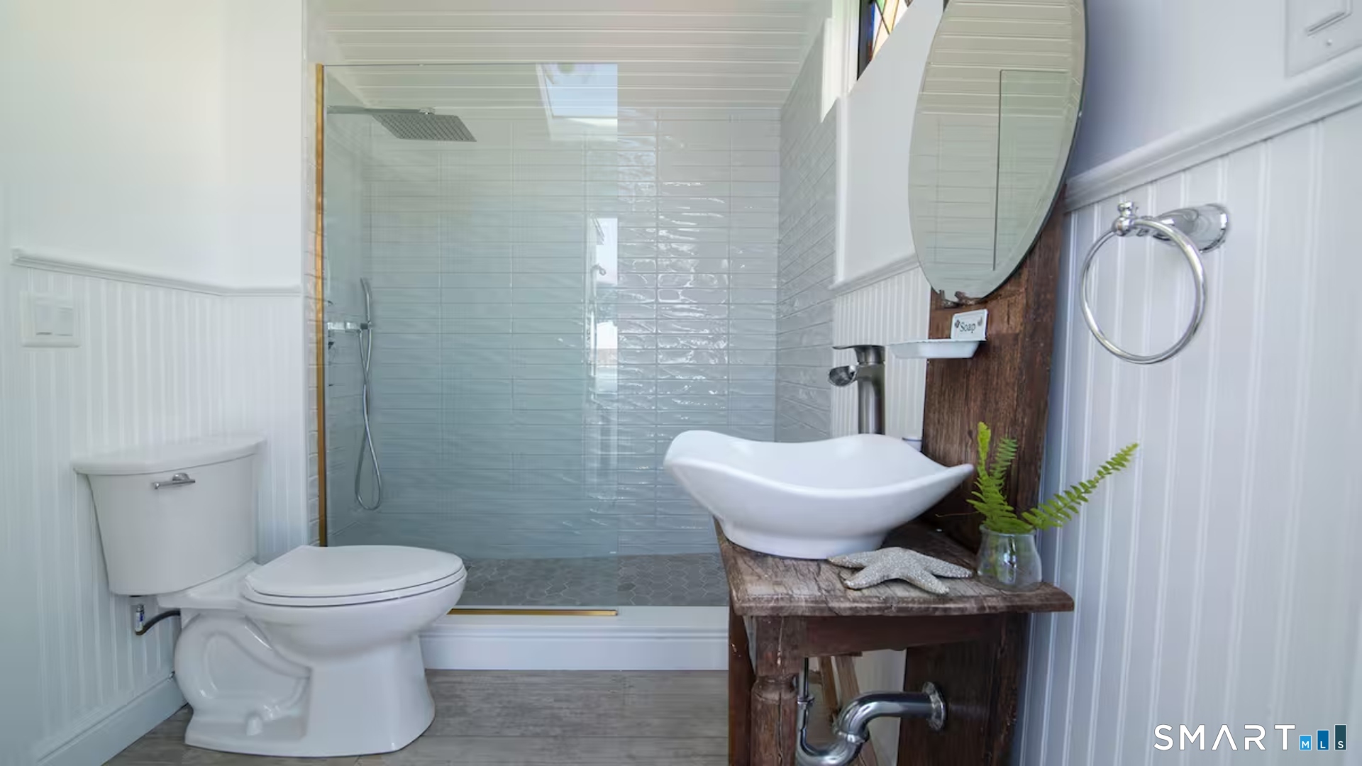 114 Jupiter Point Road Groton, CT 06340 - Photo 18 of 34 a bathroom with a toilet a sink and a mirror