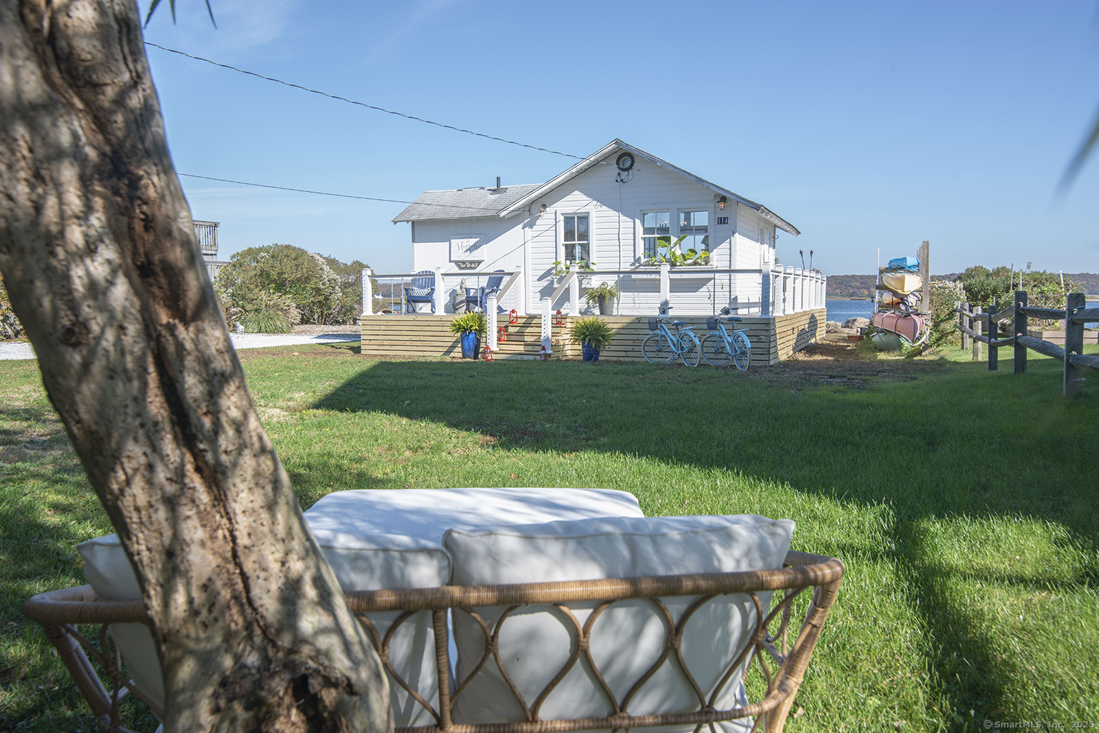 114 Jupiter Point Road Groton, CT 06340 - Photo 21 of 34 a view of a big house with a yard table and chairs