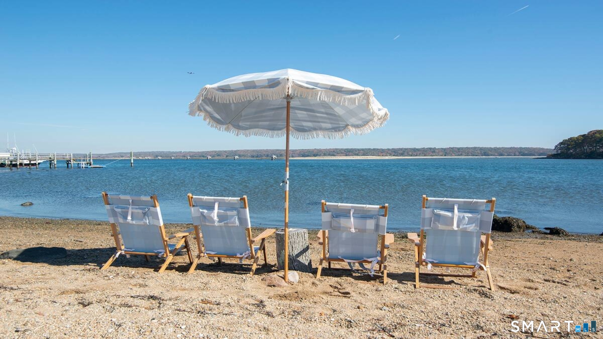 114 Jupiter Point Road Groton, CT 06340 - Photo 30 of 34 a view of a chairs and table in the sand