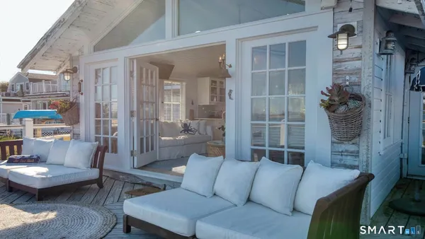 a balcony with furniture and a potted plant