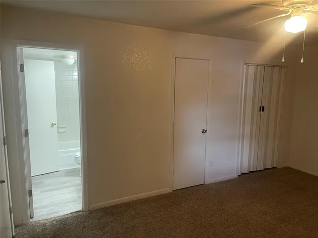 an empty room with a empty space and a ceiling fan