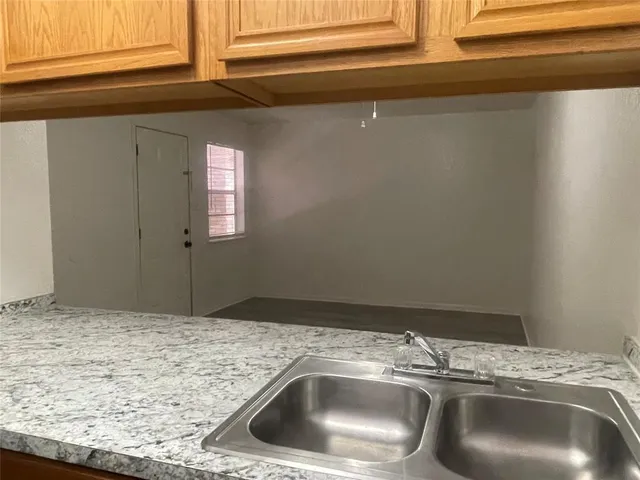 a view of a kitchen with a sink and a stove