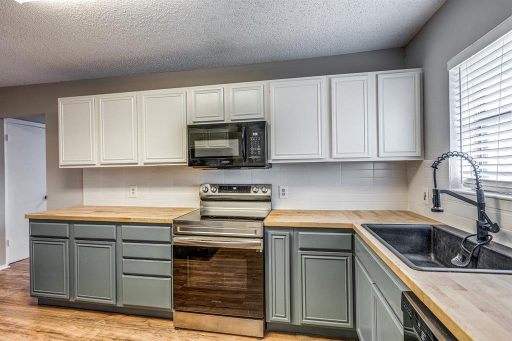 312 Mockingbird Lane Denton, TX 76209 - Photo 11 of 25 Kitchen with wood flooring and plenty of counter space.