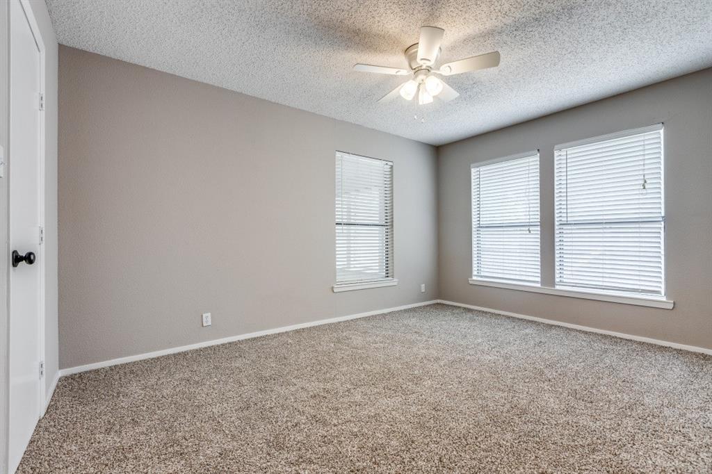 312 Mockingbird Lane Denton, TX 76209 - Photo 14 of 25 Bedroom with carpet, ceiling fan and large windows allowing for plenty of natural light.
