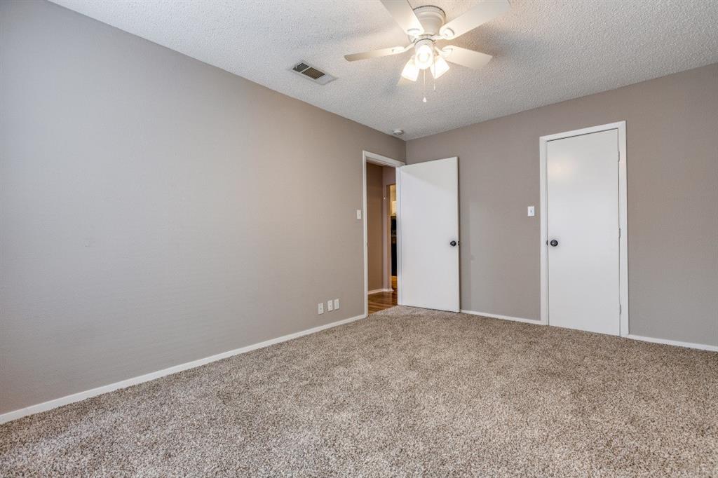 312 Mockingbird Lane Denton, TX 76209 - Photo 15 of 25 Bedroom with carpet, ceiling fan and large windows allowing for plenty of natural light.