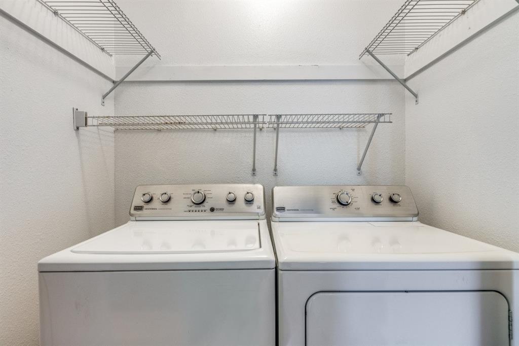 312 Mockingbird Lane Denton, TX 76209 - Photo 21 of 25 Laundry area with a textured wall and washing machine and clothes dryer