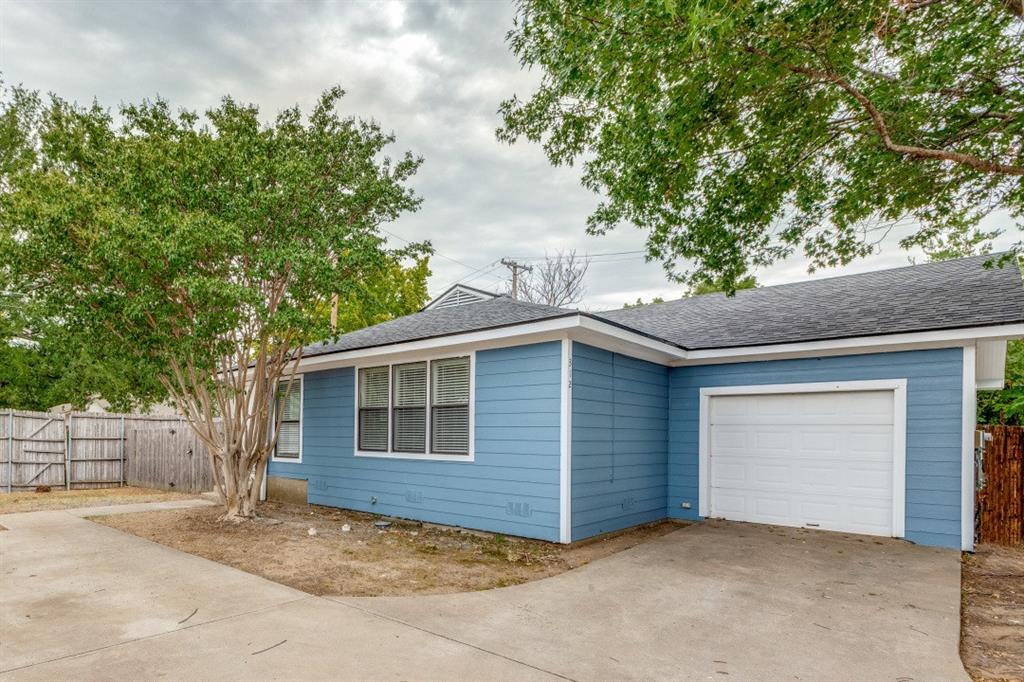 312 Mockingbird Lane Denton, TX 76209 - Photo 22 of 25 Front of structure with large driveway and garage.