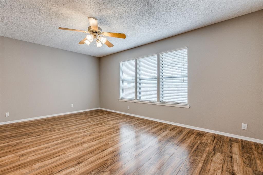 312 Mockingbird Lane Denton, TX 76209 - Photo 4 of 25 Living room with wood flooring and ceiling fan.