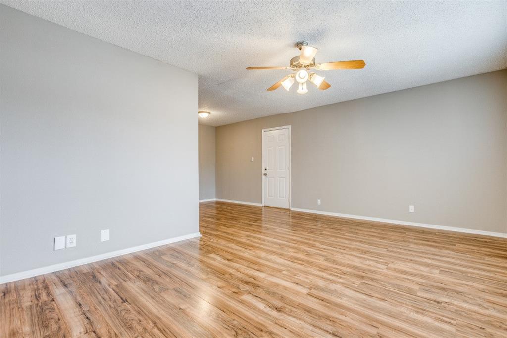 312 Mockingbird Lane Denton, TX 76209 - Photo 8 of 25 Living room with wood flooring and ceiling fan.