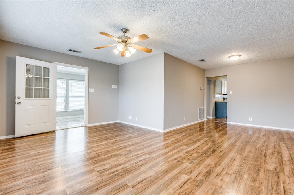 312 Mockingbird Lane Denton, TX 76209 - Photo 9 of 25 Living room with wood flooring and ceiling fan.