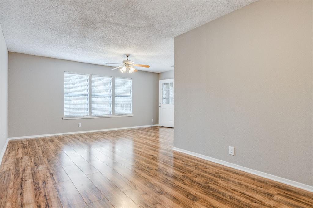 312 Mockingbird Lane Denton, TX 76209 - Photo 10 of 25 Living room with wood flooring and ceiling fan.
