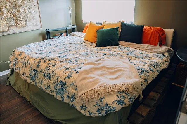 a bedroom with a bed and a mirror