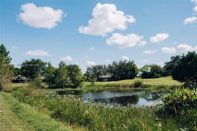 a view of a backyard with wooden fence