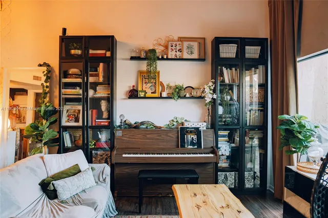 a living room with furniture and a potted plant