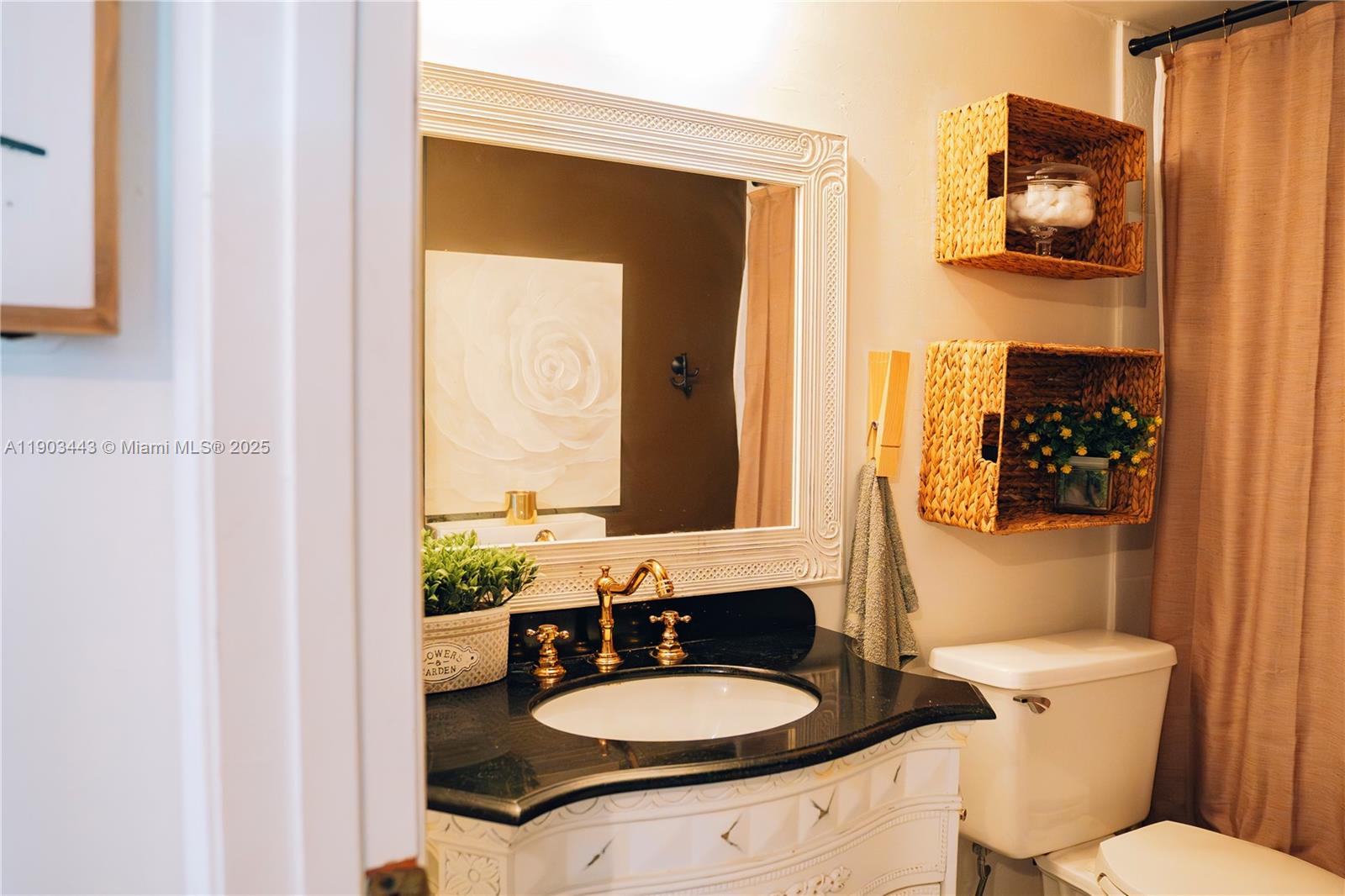 2152 Southwest 81st Way Davie, FL 33324 - Photo 10 of 27 a bathroom with a toilet a sink and mirror