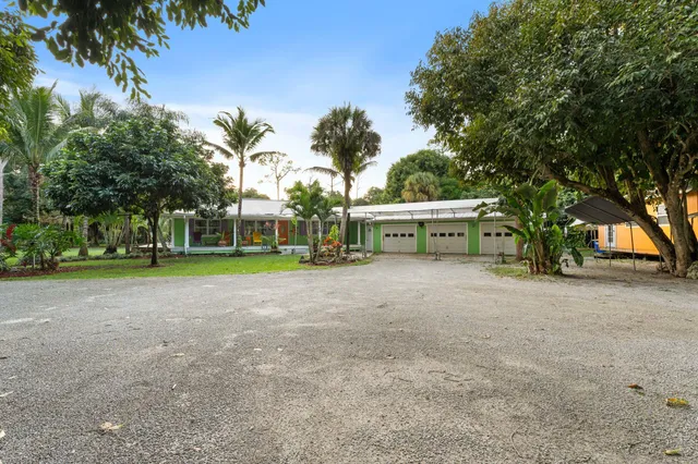 a view of a house with a yard and entertaining space