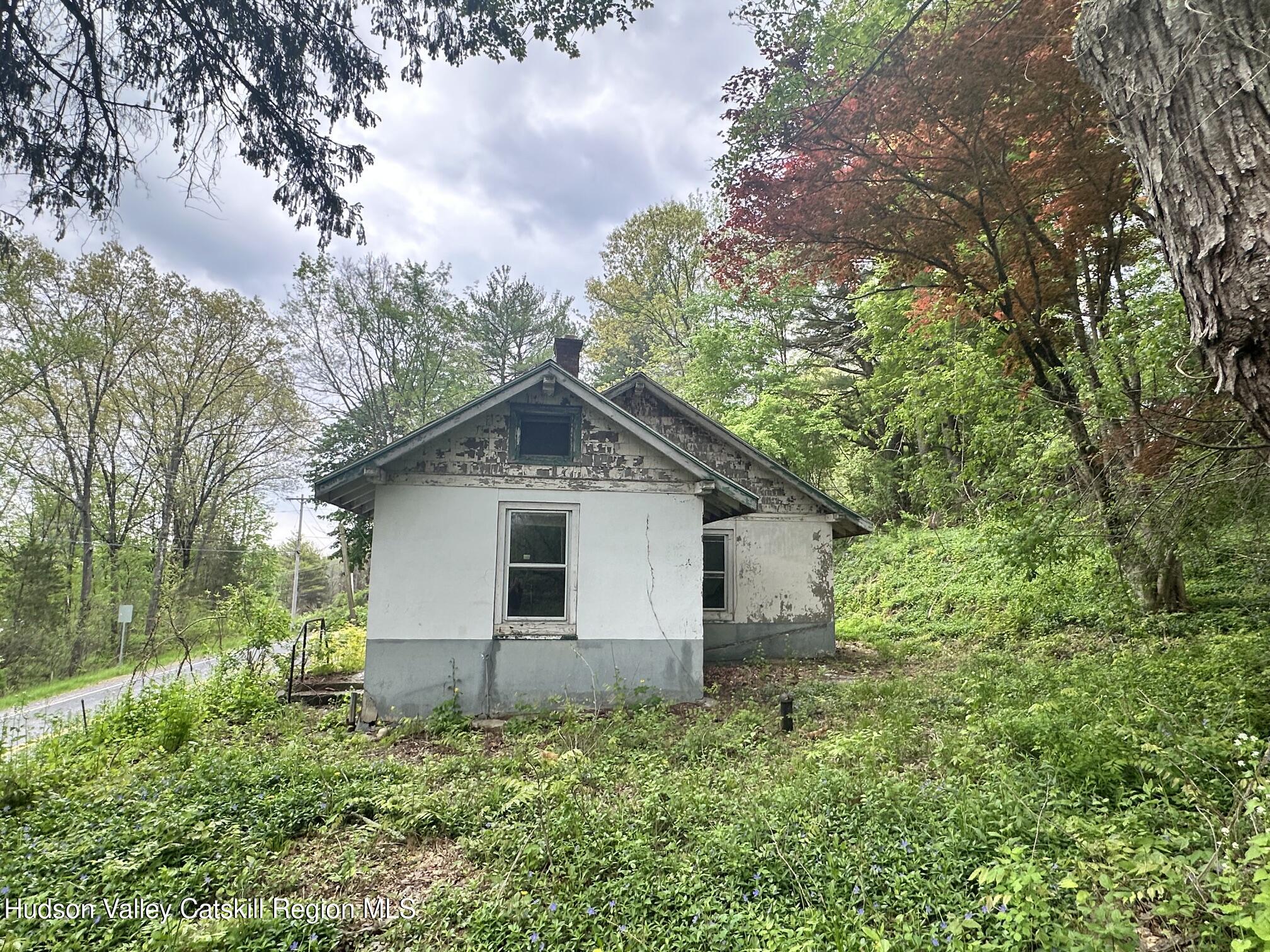 1033 Co Rte 8 Germantown, NY 12526 - Photo 4 of 14 a white house that has a small yard and large trees