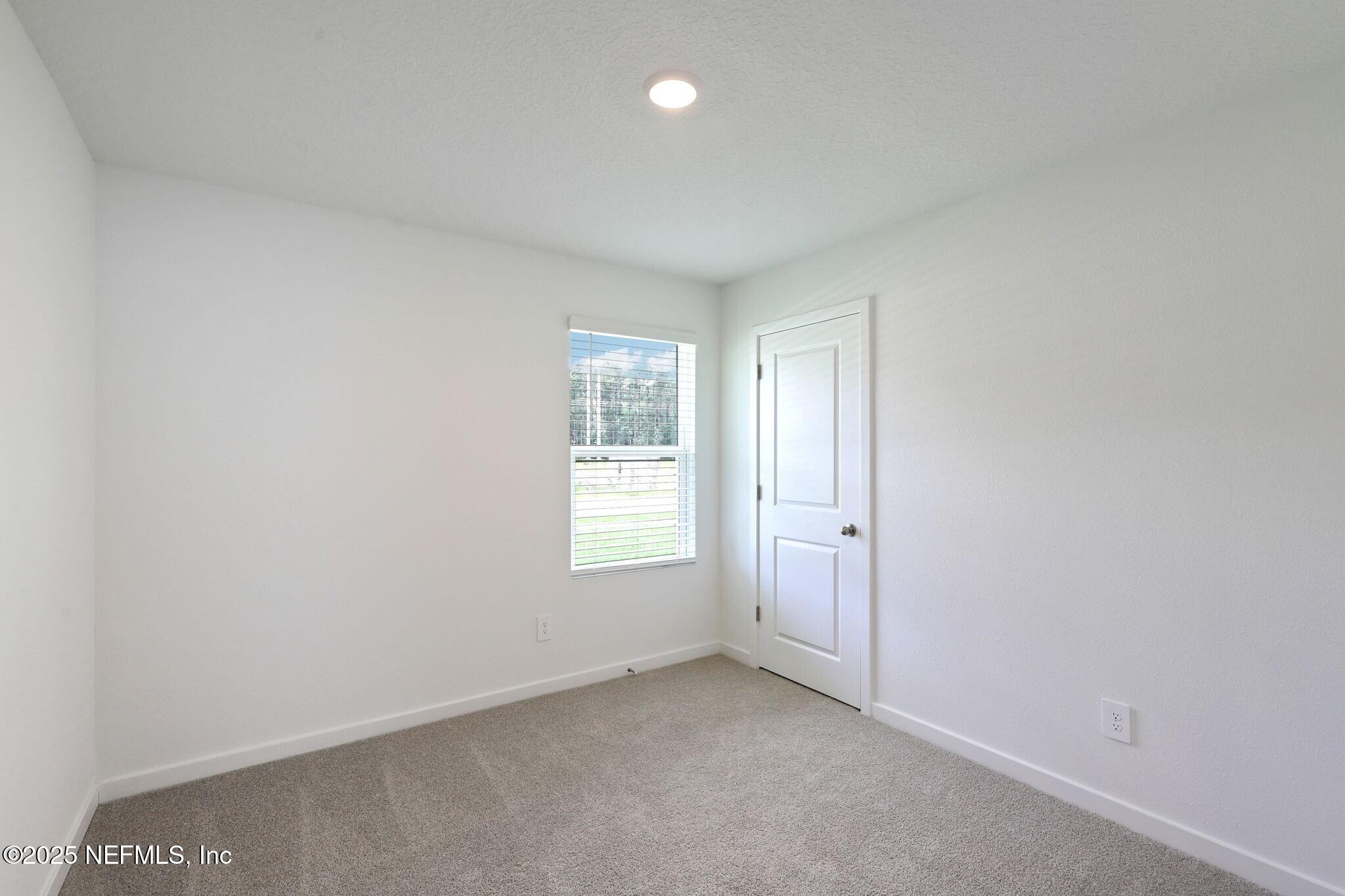 9709 Amber Vlg Road Jacksonville, FL 32219 - Photo 11 of 25 an empty room with windows