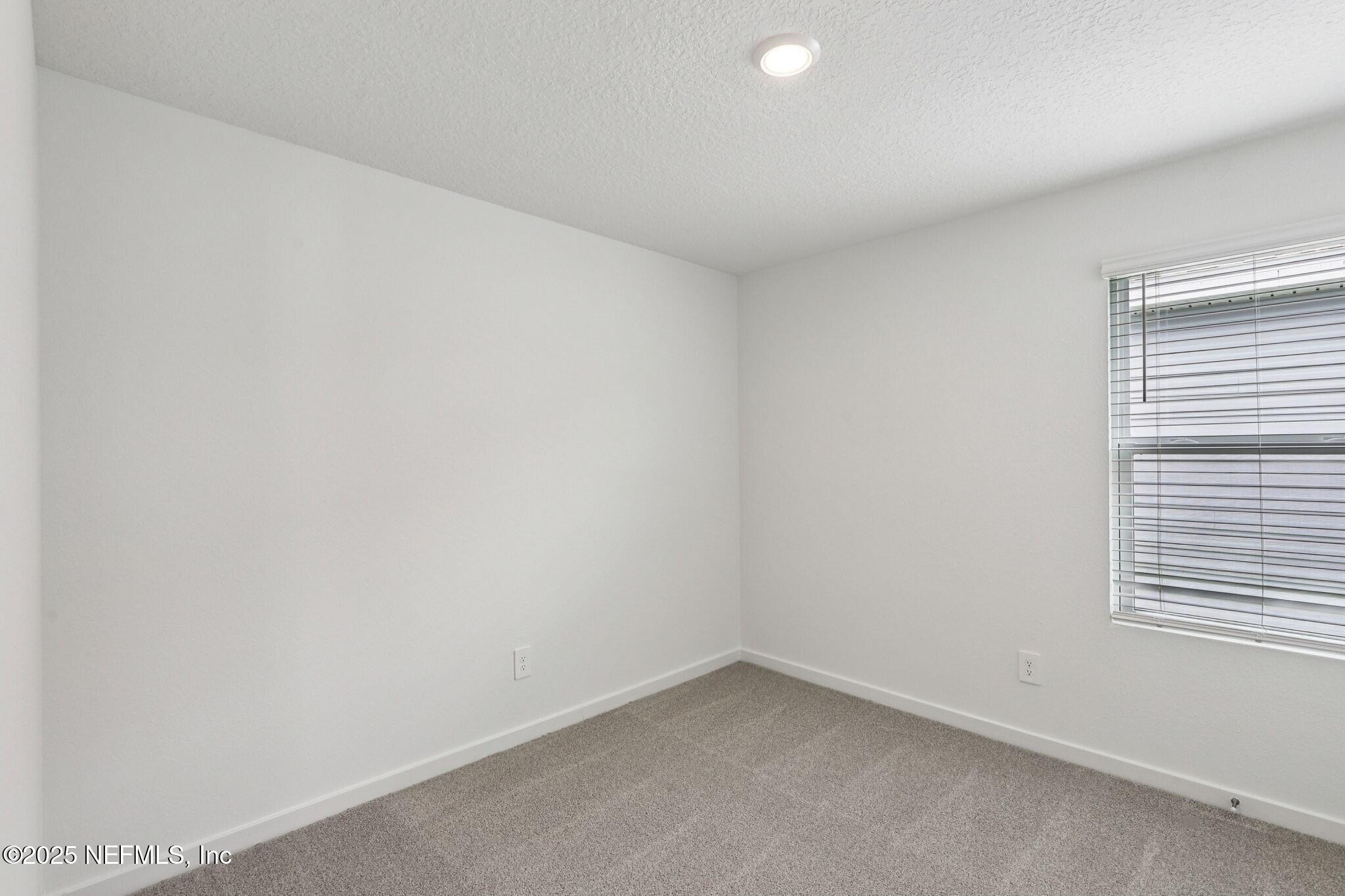 9709 Amber Vlg Road Jacksonville, FL 32219 - Photo 13 of 25 a view of an empty room with a window