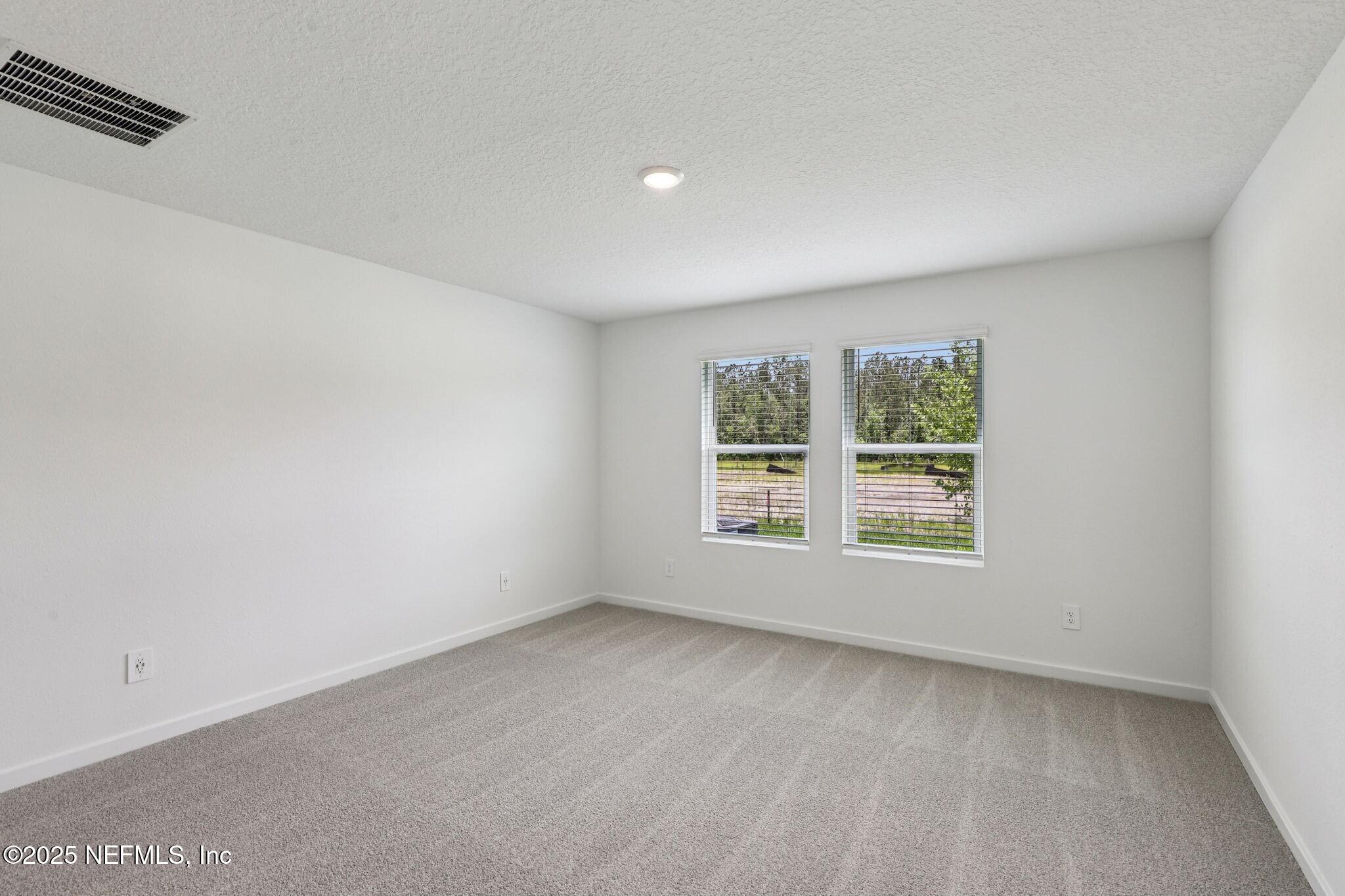 9709 Amber Vlg Road Jacksonville, FL 32219 - Photo 16 of 25 an empty room with a window