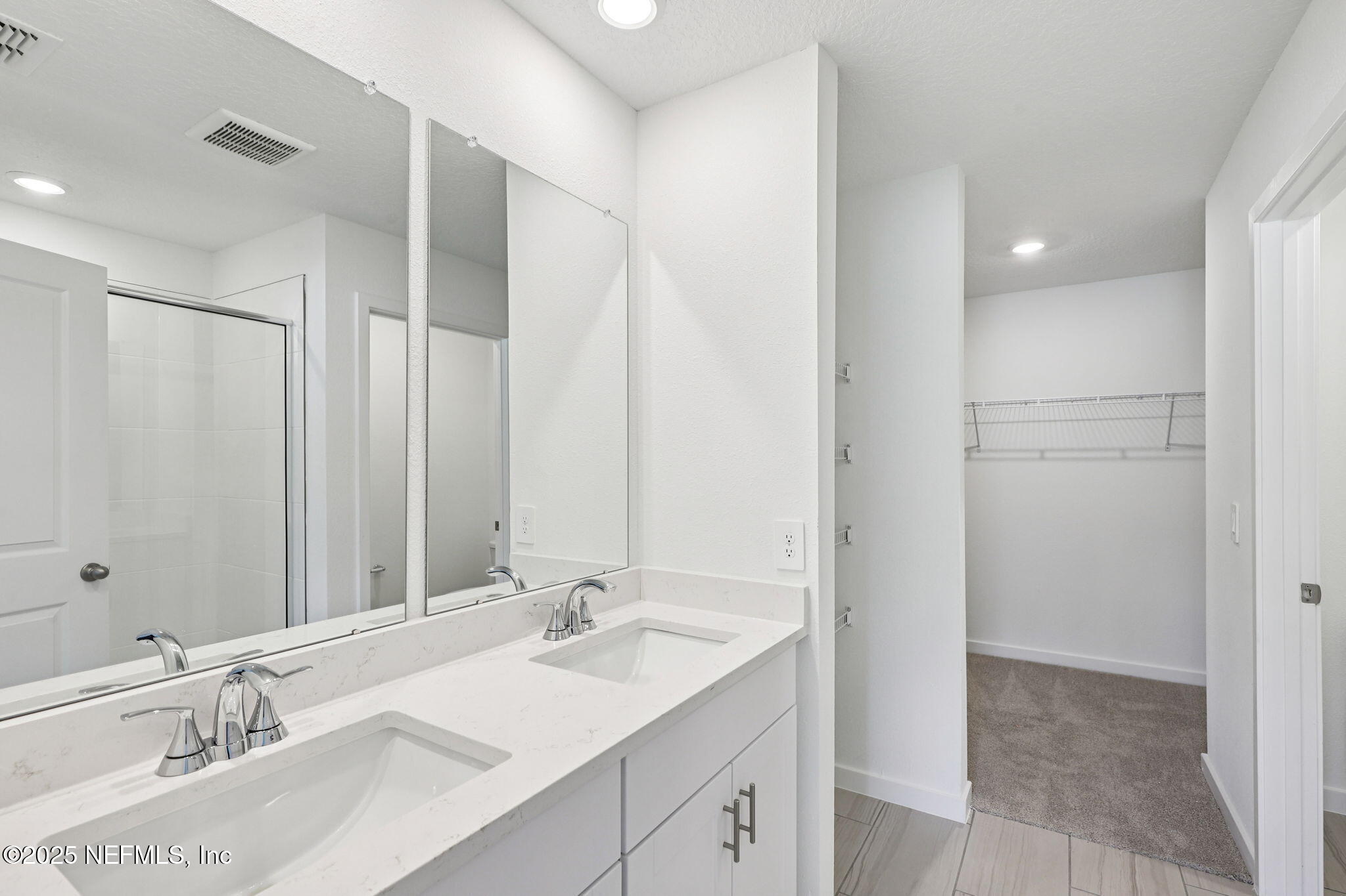 9709 Amber Vlg Road Jacksonville, FL 32219 - Photo 19 of 25 a bathroom with a sink double vanity and a mirror