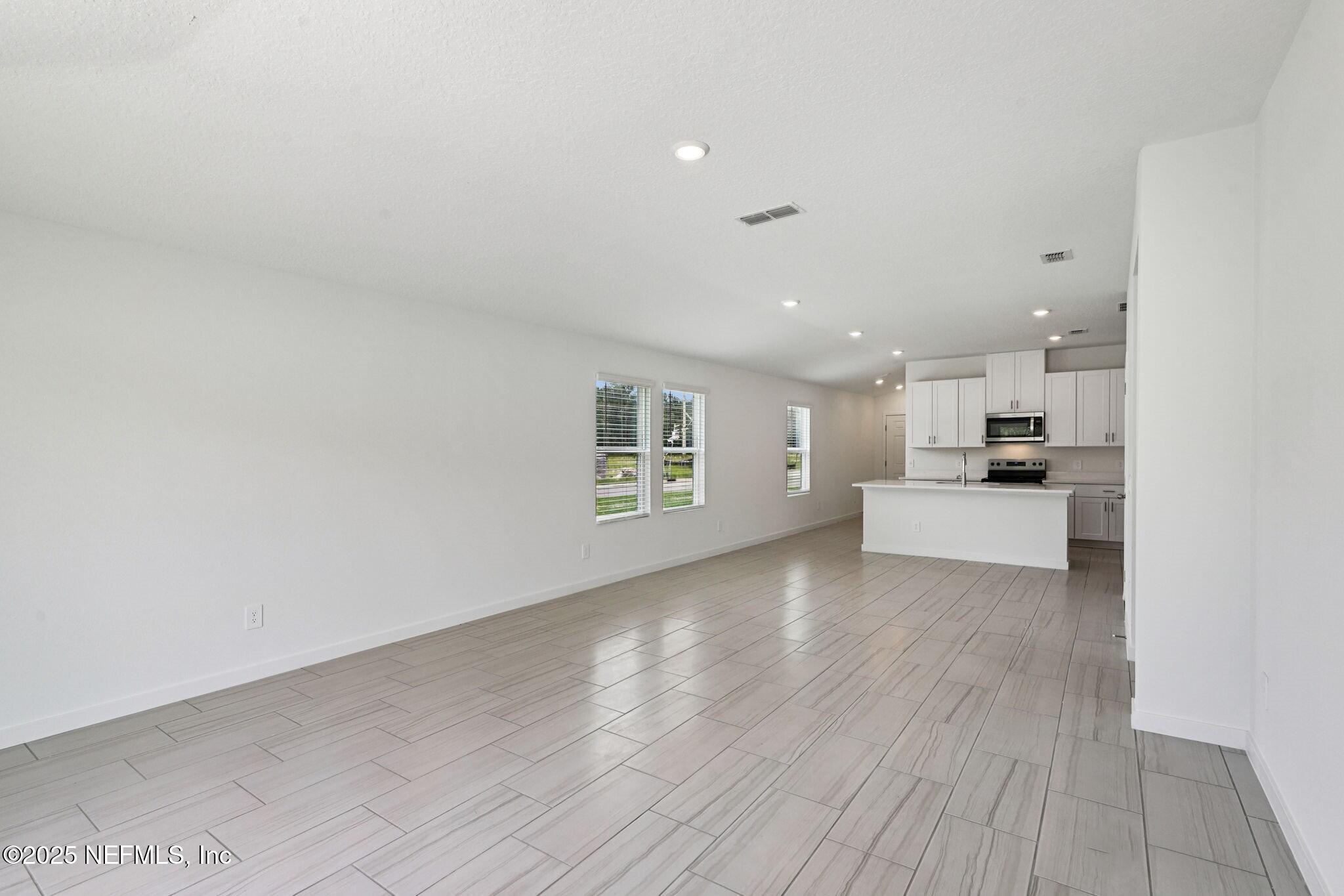 9709 Amber Vlg Road Jacksonville, FL 32219 - Photo 6 of 25 a view of kitchen and hall with wooden floor