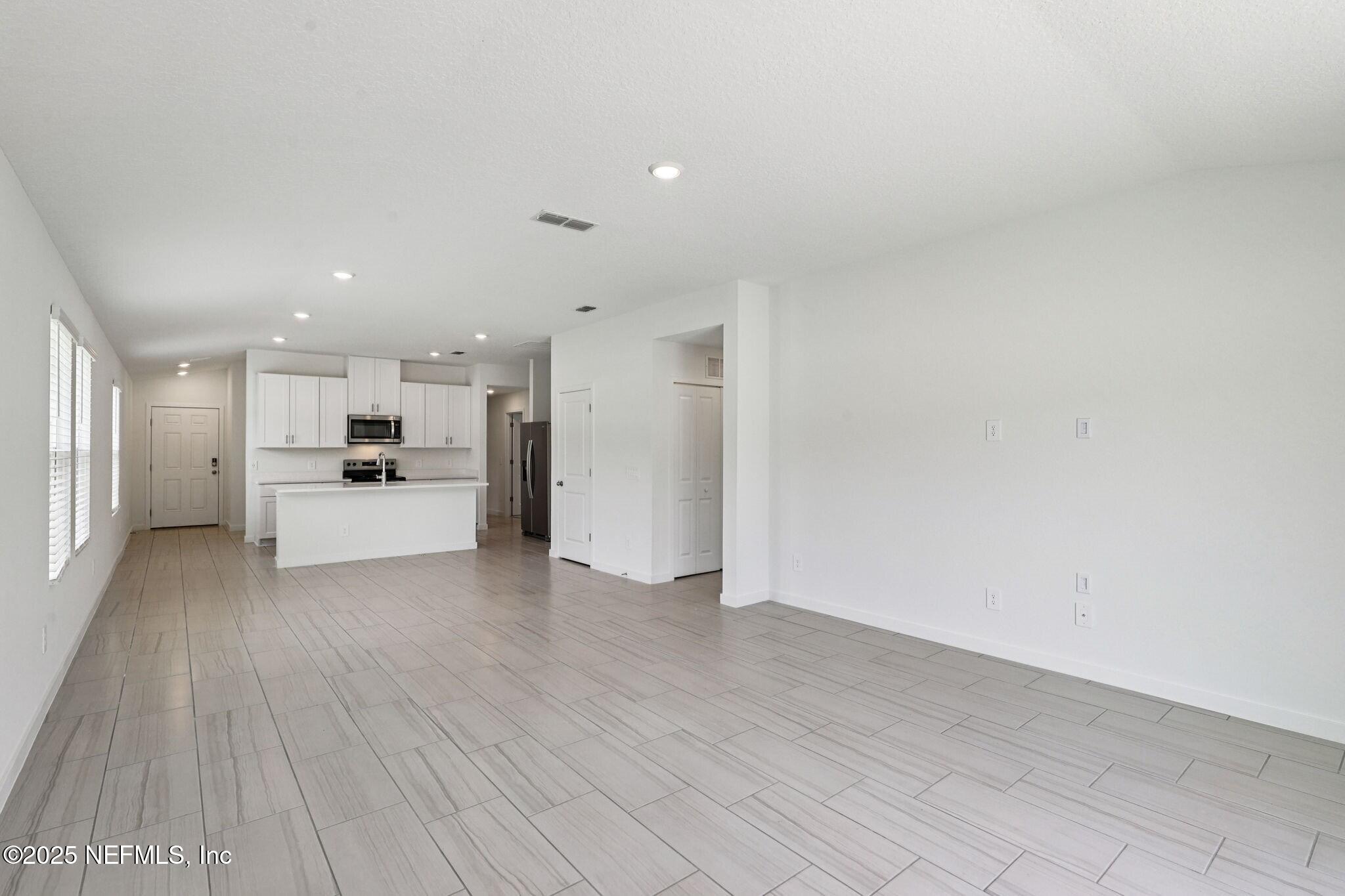 9709 Amber Vlg Road Jacksonville, FL 32219 - Photo 7 of 25 a view of a kitchen with a sink and a refrigerator