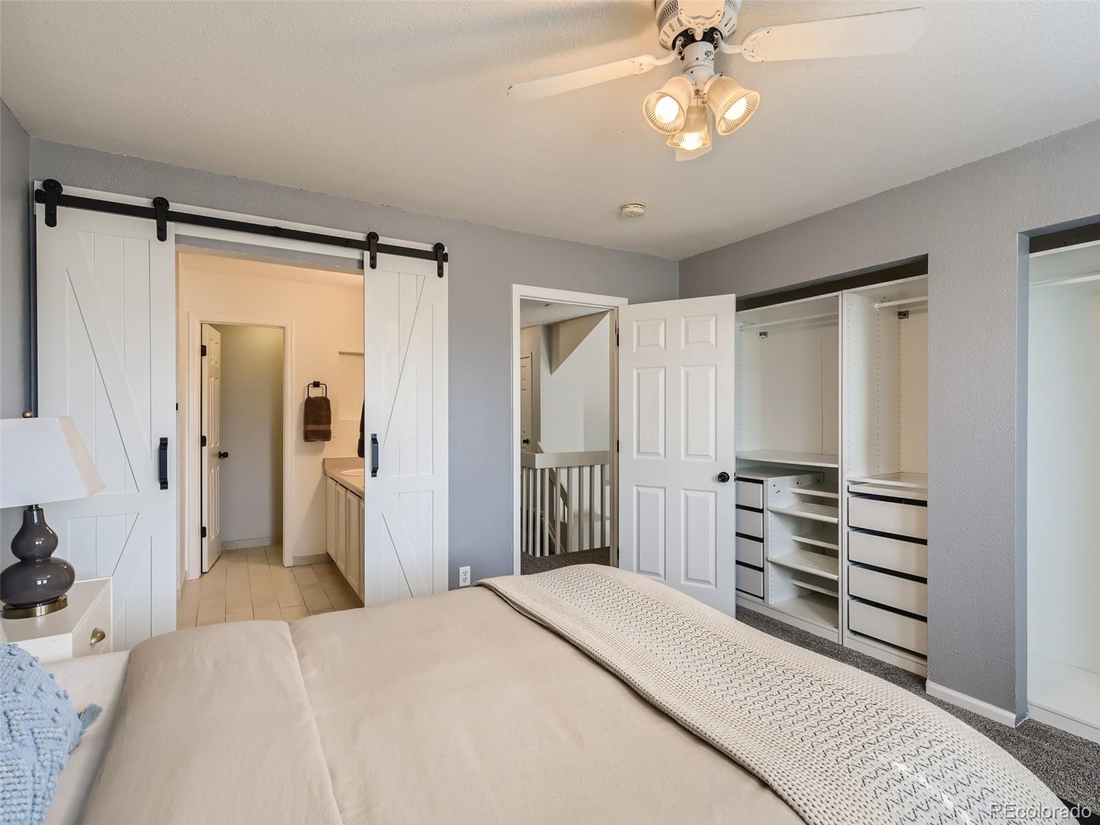 9760 South Castle Ridge Circle Highlands Ranch, CO 80129 - Photo 11 of 25 a bedroom with a bed and a chandelier