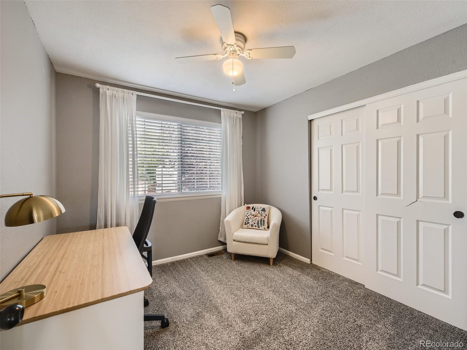 9760 South Castle Ridge Circle Highlands Ranch, CO 80129 - Photo 14 of 25 a bed room with a bed and a chair
