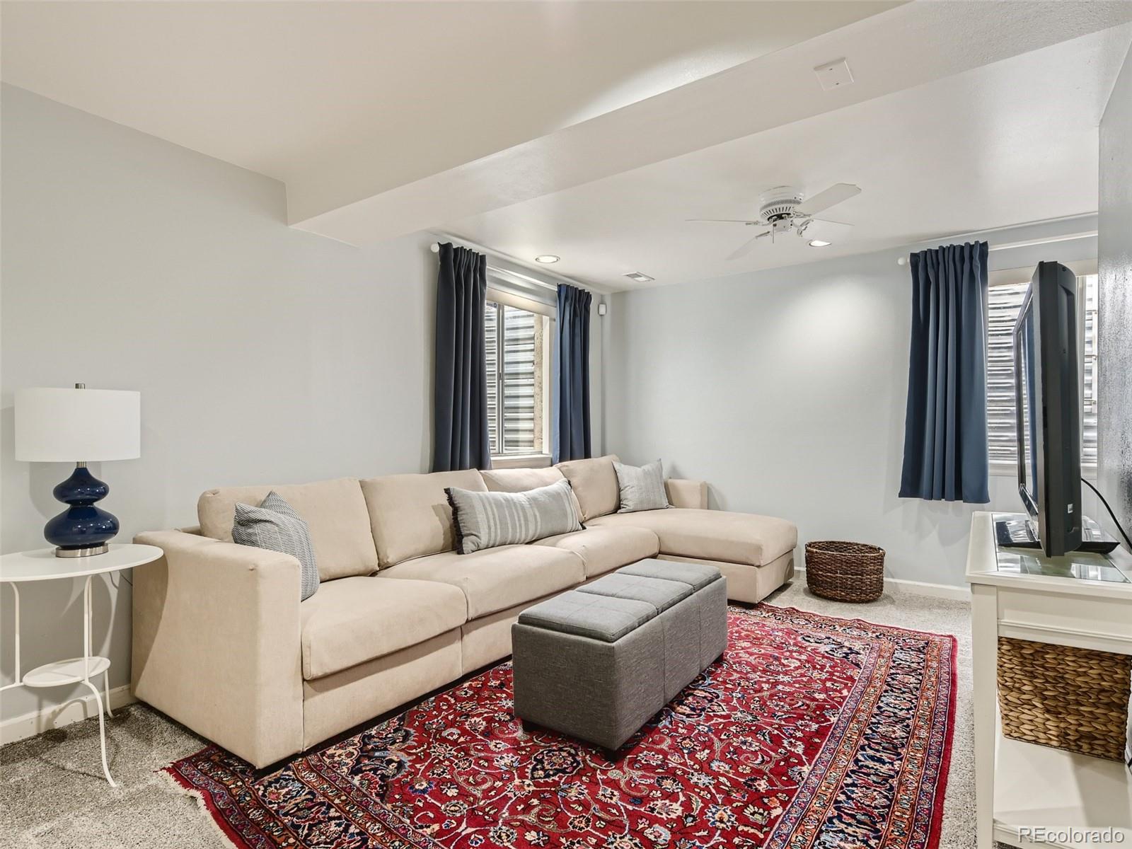 9760 South Castle Ridge Circle Highlands Ranch, CO 80129 - Photo 18 of 25 a living room with furniture and a flat screen tv