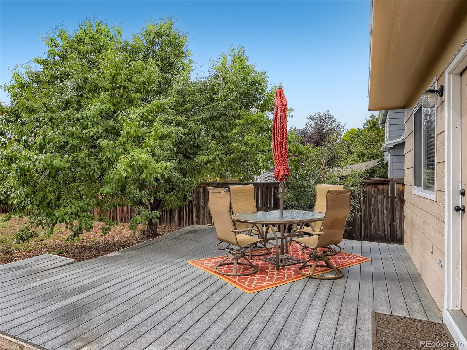9760 South Castle Ridge Circle Highlands Ranch, CO 80129 - Photo 20 of 25 a view of deck with table and chairs and wooden floor