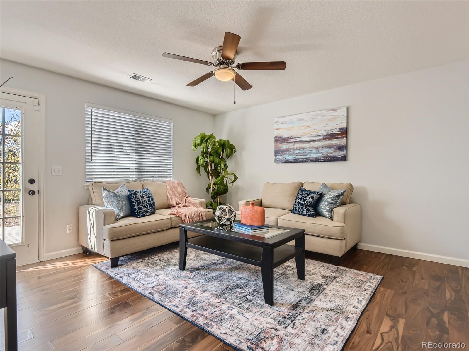 9760 South Castle Ridge Circle Highlands Ranch, CO 80129 - Photo 8 of 25 a living room with furniture and a rug