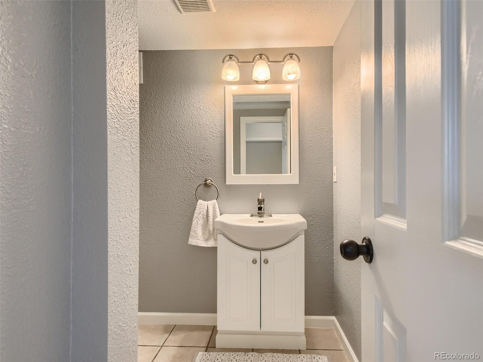 9760 South Castle Ridge Circle Highlands Ranch, CO 80129 - Photo 9 of 25 a bathroom with a sink toilet and shower