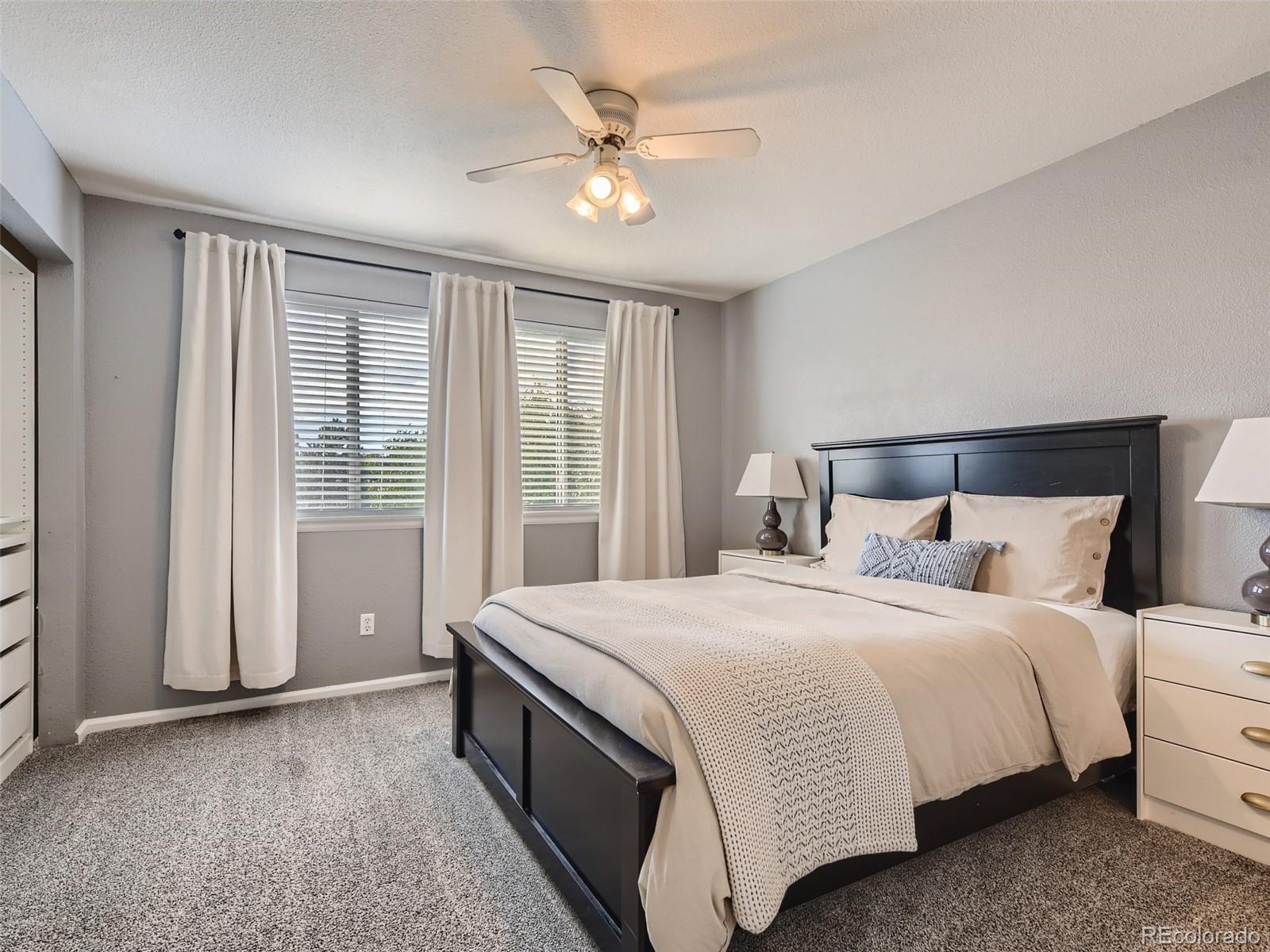 9760 South Castle Ridge Circle Highlands Ranch, CO 80129 - Photo 10 of 25 a bedroom with a bed and a large window