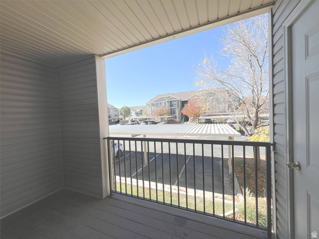 8198 North Cedar Springs Road, Unit T6 Eagle Mountain, UT 84005 - Photo 11 of 13 Private balcony featuring wood-finish flooring, horizontal siding, and a metal railing