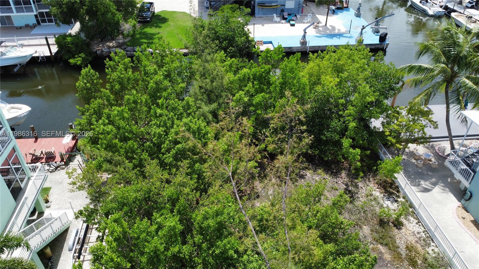 Key Largo Key Largo, FL 33037 - Photo 1 of 6 an aerial view of a house with a yard and lake view