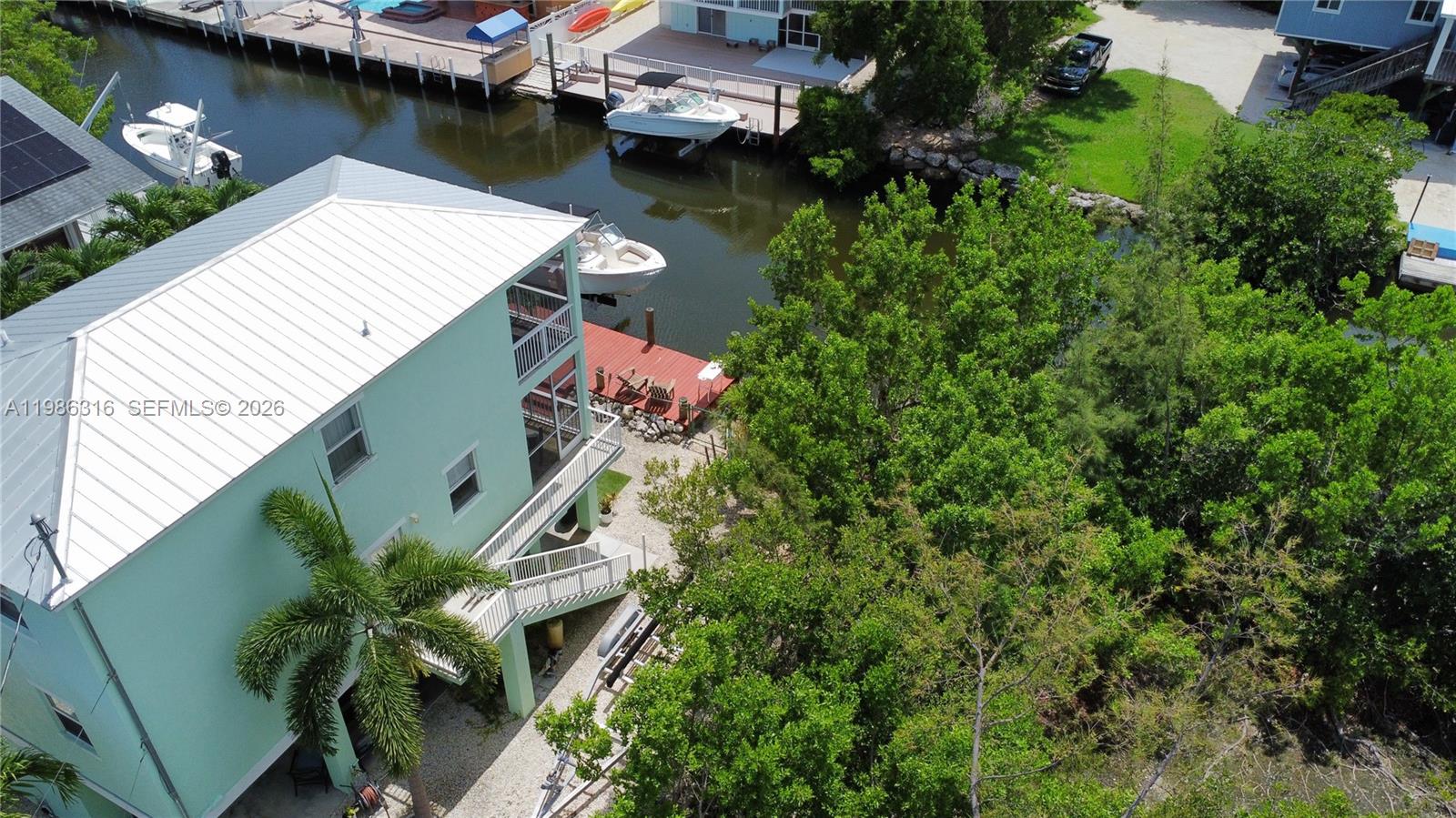 Key Largo Key Largo, FL 33037 - Photo 3 of 6 an aerial view of a house with outdoor space and a lake view
