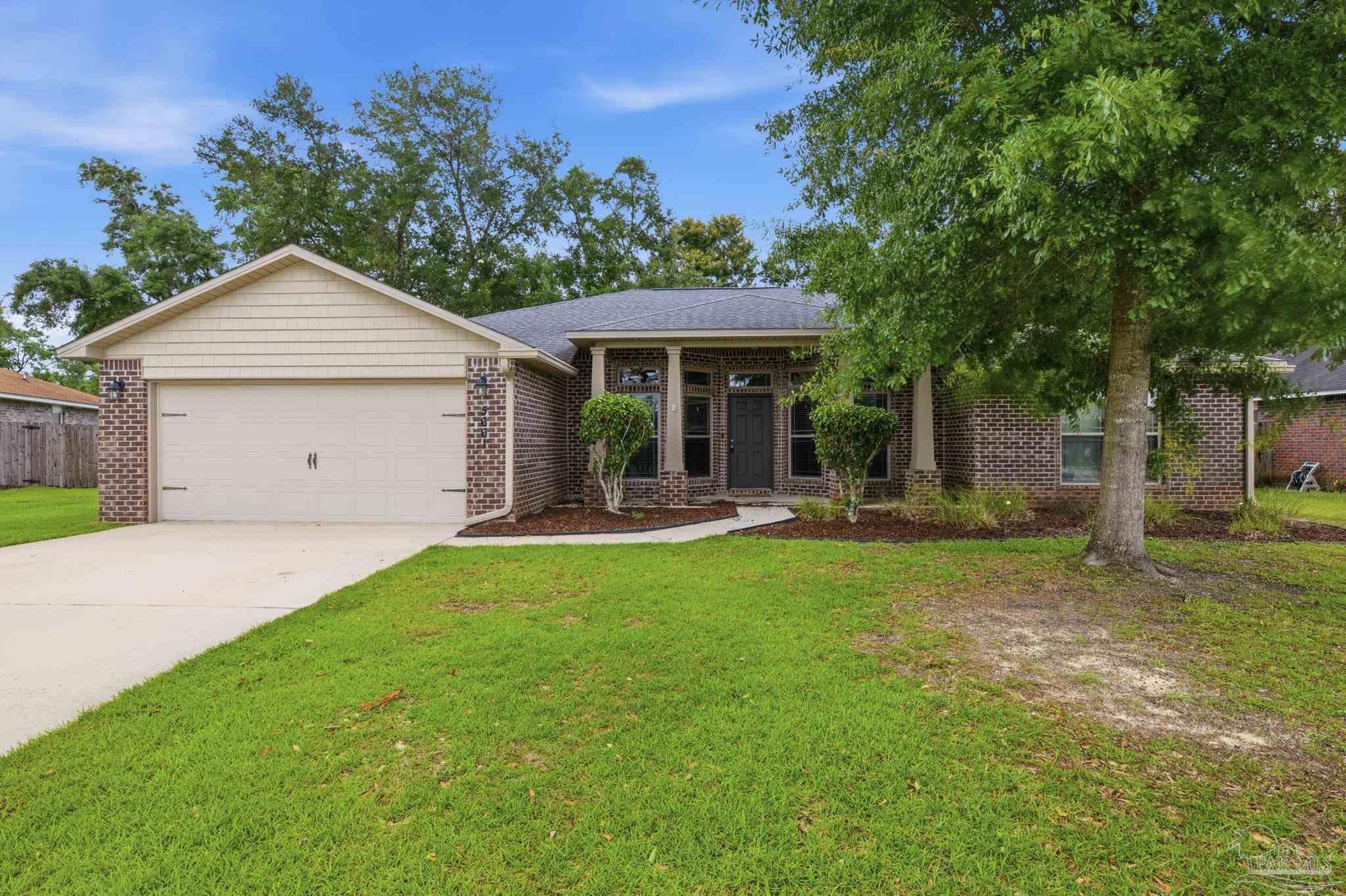 5661 Cane Syrup Circle Pace, FL 32571 - Photo 1 of 20 a view of a house with backyard and a tree