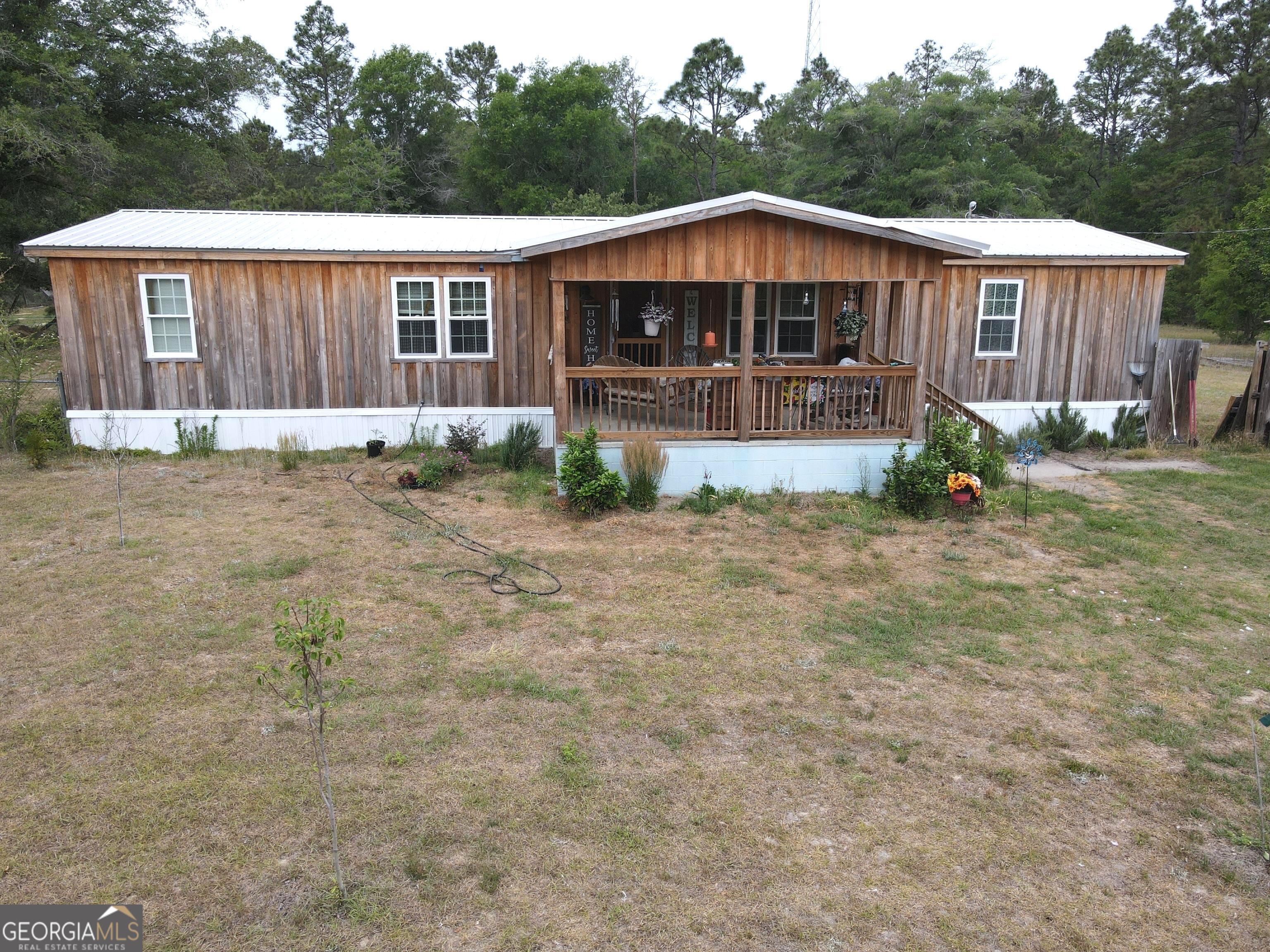 19 Cow Ford Bridge Road Adrian, GA 31002 - Photo 1 of 22 a front view of a house with garden