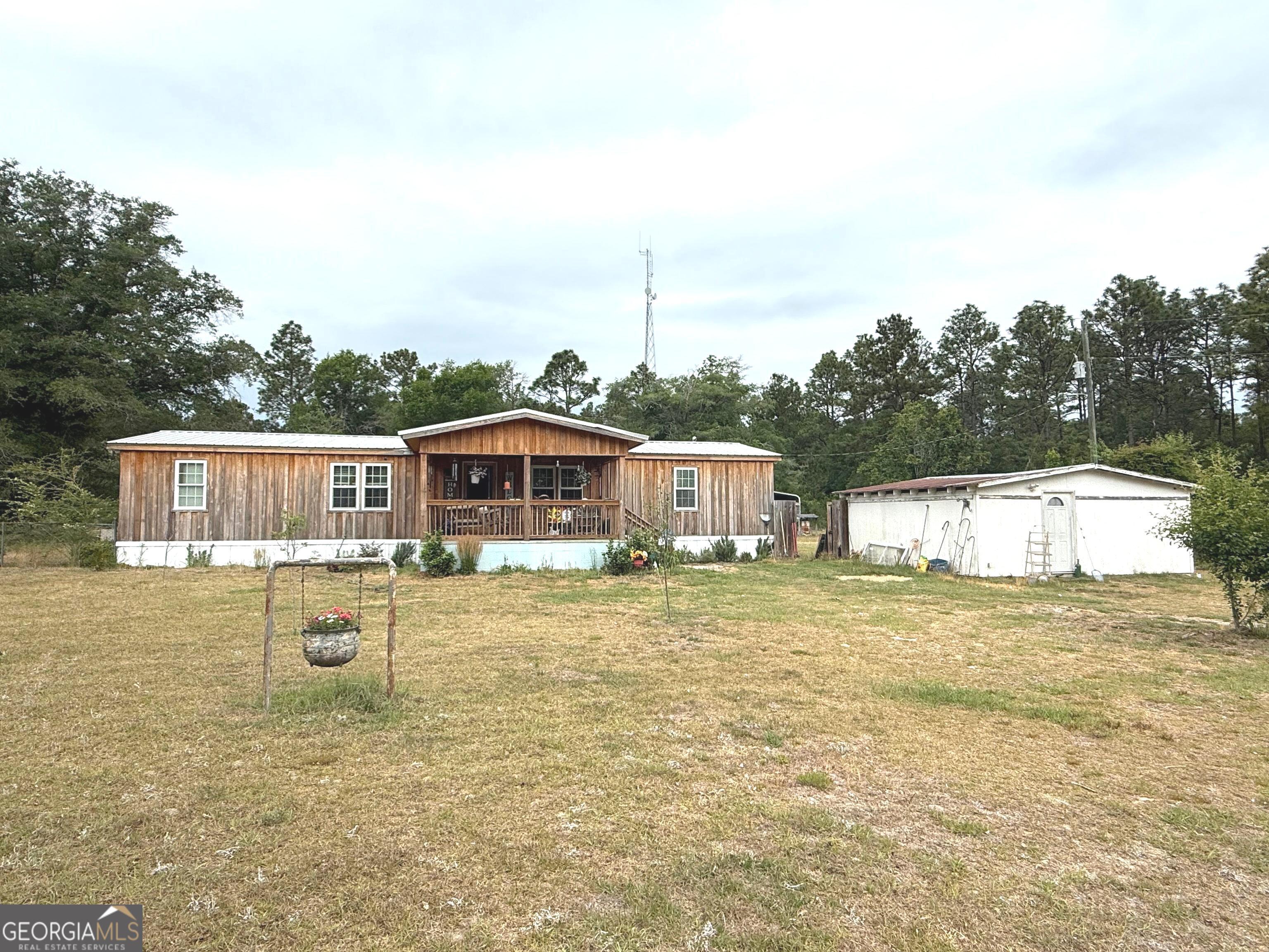 19 Cow Ford Bridge Road Adrian, GA 31002 - Photo 3 of 22 a front view of a house with a yard
