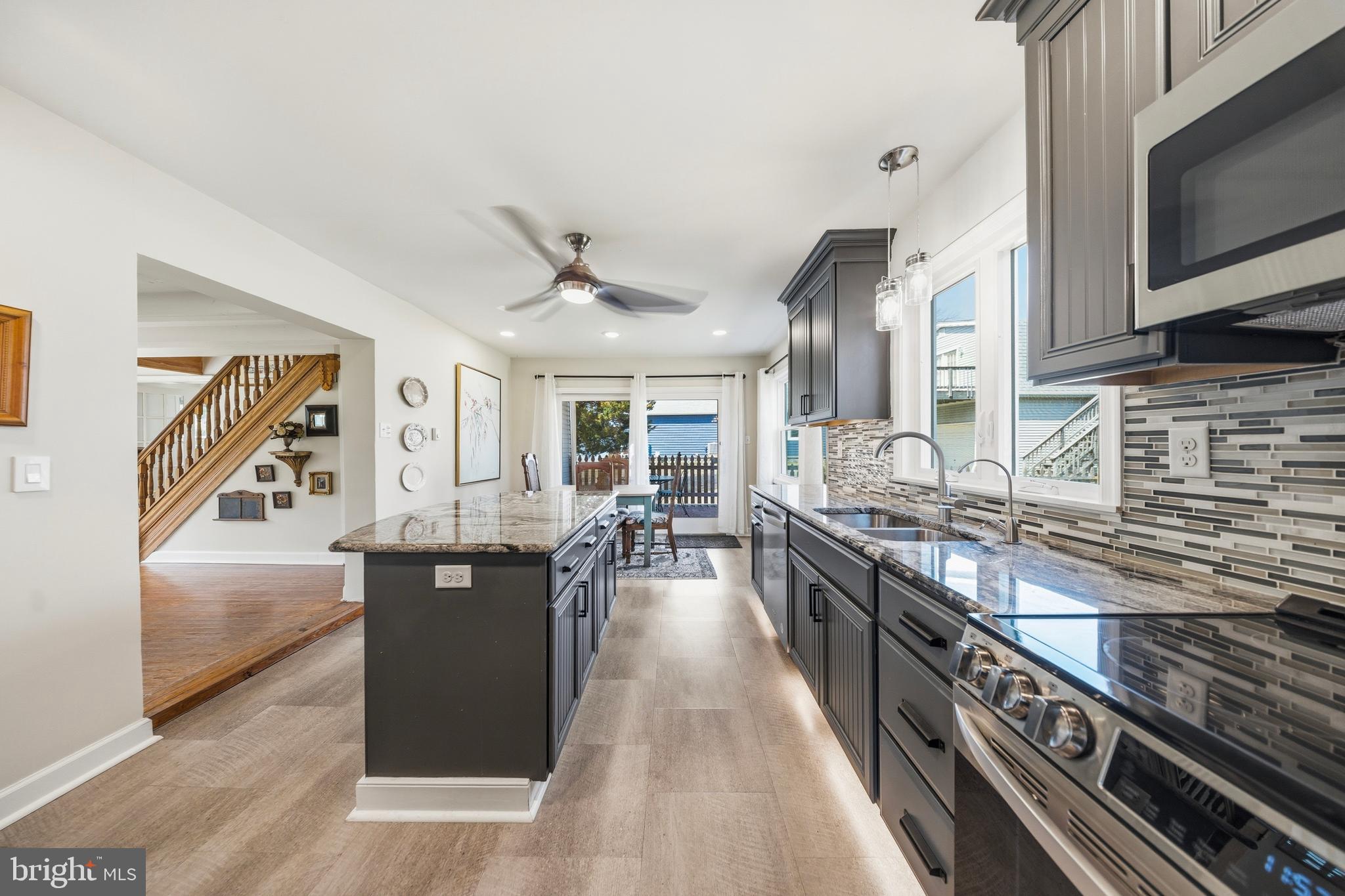 20826 Bivalve Wharf Road Bivalve, MD 21865 - Photo 19 of 52 a large kitchen with granite countertop a large counter top space a sink stainless steel appliances and cabinets