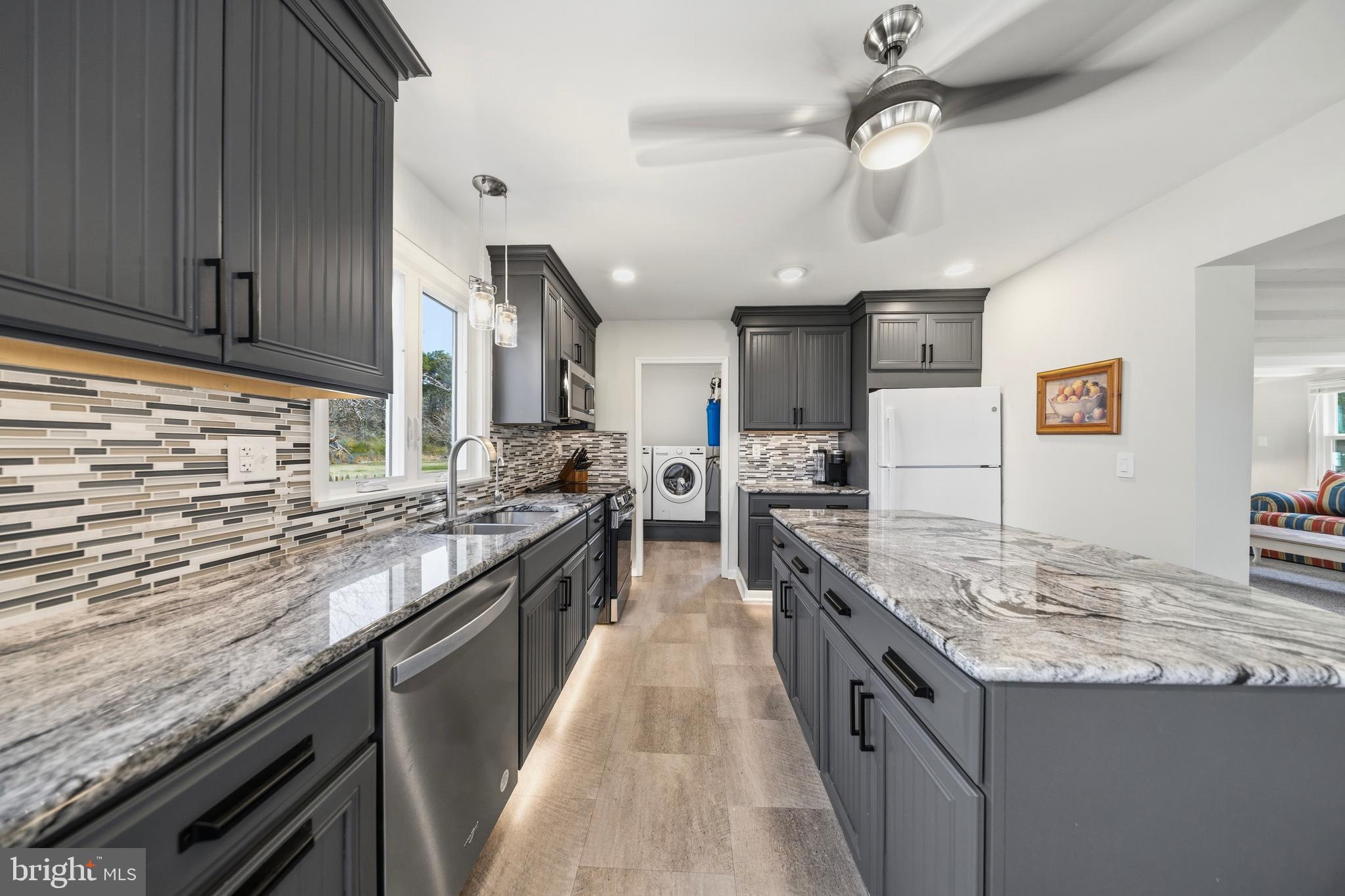 20826 Bivalve Wharf Road Bivalve, MD 21865 - Photo 20 of 52 a kitchen with stainless steel appliances granite countertop wooden cabinets and sink