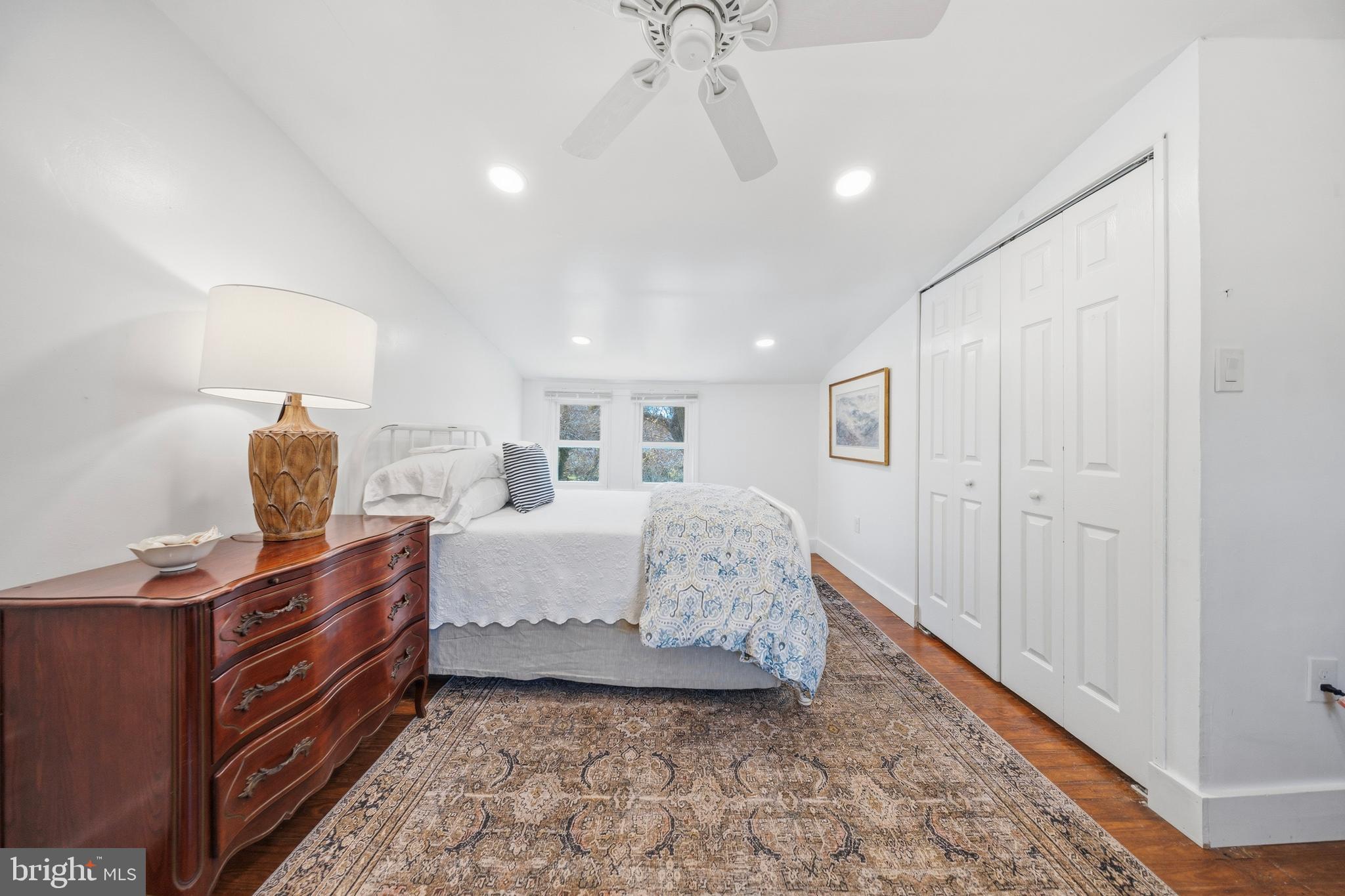 20826 Bivalve Wharf Road Bivalve, MD 21865 - Photo 28 of 52 a spacious bedroom with a bed and a chandelier