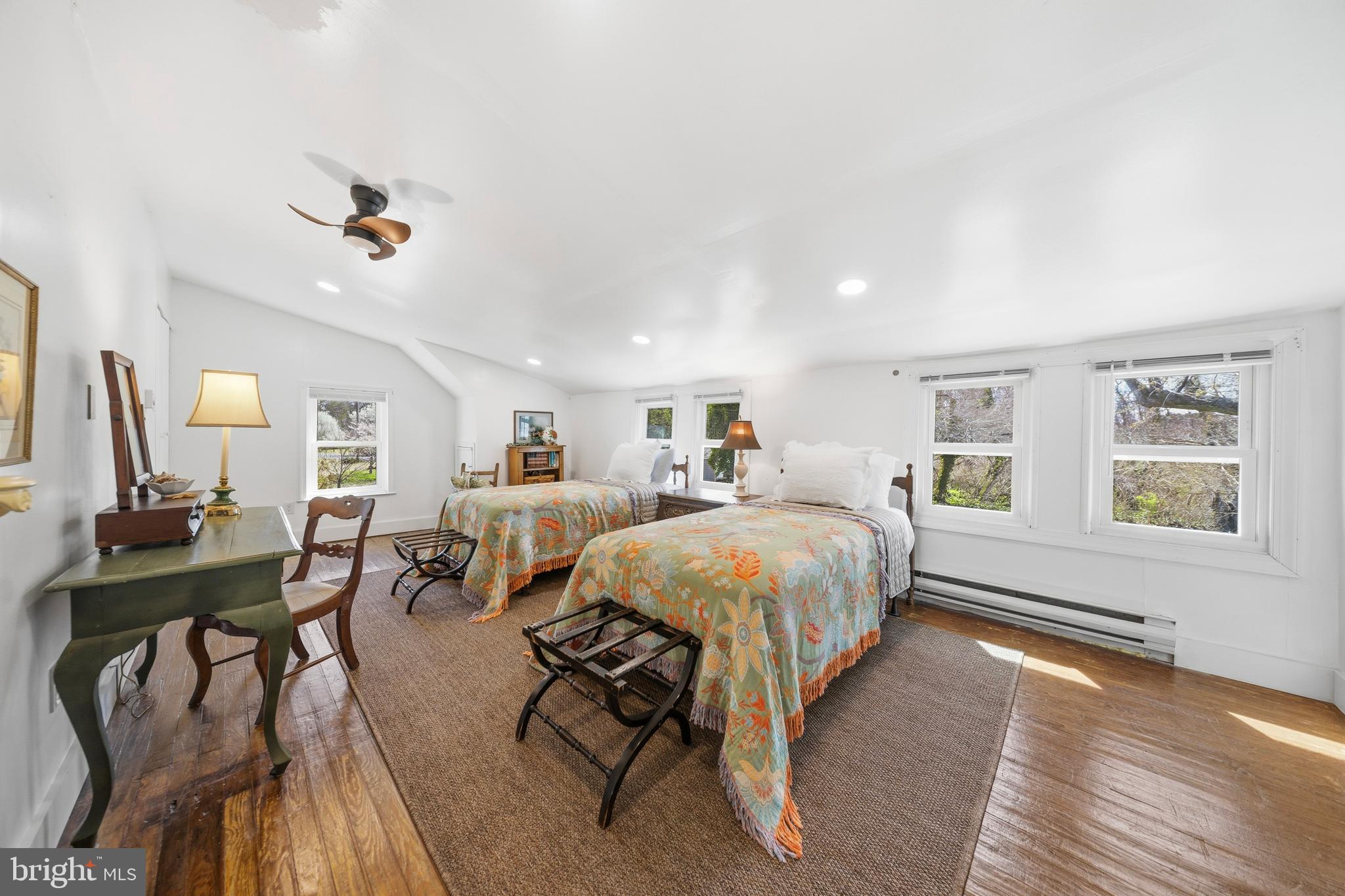 20826 Bivalve Wharf Road Bivalve, MD 21865 - Photo 32 of 52 a spacious bedroom with a bed a table and chair